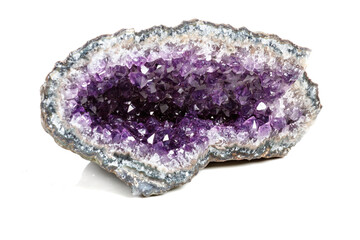 Macro Mineral Stone Amethysts in the rock on a white background