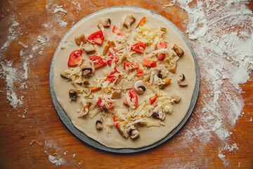 homemade vegetarian raw pizza with mushrooms and bell pepper