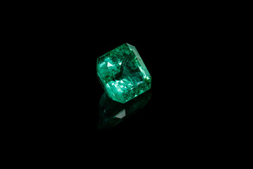 Macro mineral Emerald gemstone faceted on black background