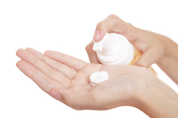 beautiful woman hand on a white background presses on a bottle of spa cleansing foam. isolate