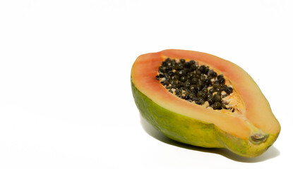 Papaya cut in half on a white background. Juicy sweet fruit. Healthy food concept.