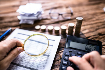 Auditor Hand Checking Invoice Using Magnifying Grass