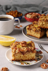 Homemade lemon pie with raisins and nuts on gray table, vertical format