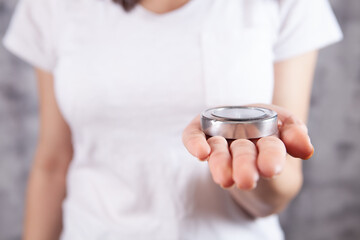 young girl holding a compass indoors