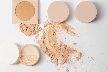 Set of make up with Crushed beige face finishing and bronzing  powder on white background...