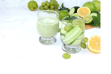 Vegetables, fruits, juices and cocktails on a light background flat lay. The concept of healthy and...