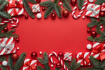 Christmas background with frame decorated with festive gifts and spruce branches