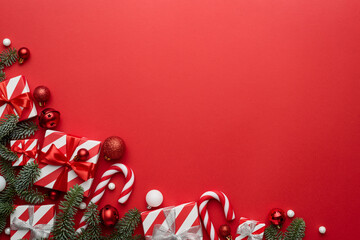 Red Christmas background with fir ornaments and holiday gifts - obrazy, fototapety, plakaty