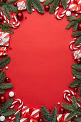 Red background with Christmas gift boxes and Christmas decorations frame