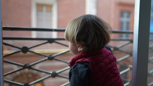 Toddler stepping down from balcony for safety reasons