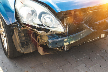 Car crash accident. Light damage and scratchs on bumper. Front side of broken and wrecked car, detail, close-up photo