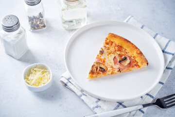 Fresh baked pizza with ham and mushrooms on a background