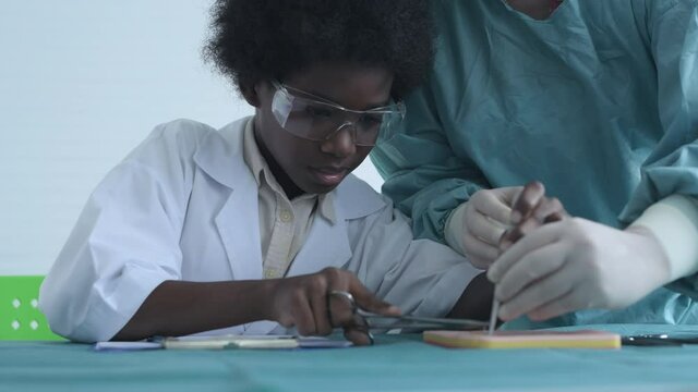 Education concept of 4k Resolution. Medical school students practicing suturing wounds in classroom.