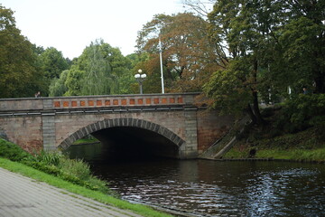 Fototapeta na wymiar The bridge on the canal in the park of Riga. High quality photo