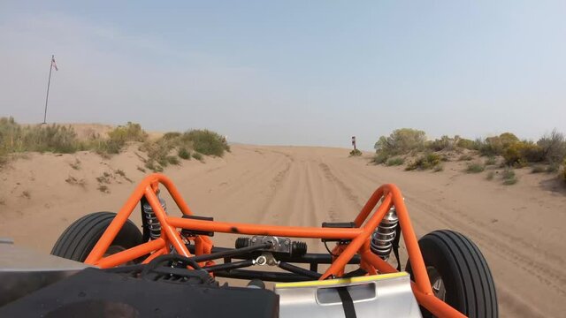 Orange Dune Buggy Driving in the Sand Dunes