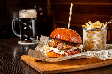 tasty burger with french fries and beer