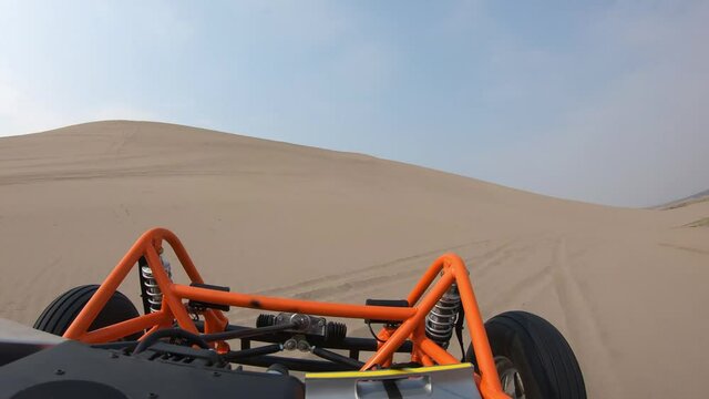 Orange Dune Buggy Driving in the Sand Dunes