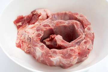 Raw pork ribs in white bowl