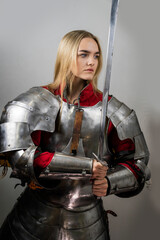 A beautiful warrior woman  with a sword and in armor, Medieval knight