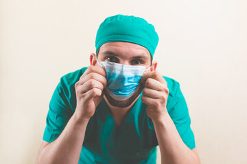 Young doctor and protective breathing mask