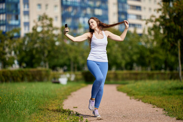 Video blogger is making call in park by phone.