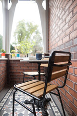 A dining setting on the patio of an old federation house with tuckpointing brickwork and tiling