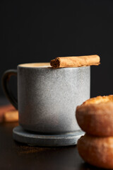 A hot and fresh cinnamon coffee with a cinnamon stick