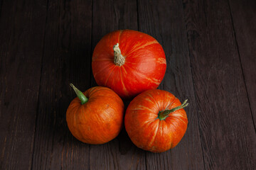 Pumpkins on wooden table in dark mood.