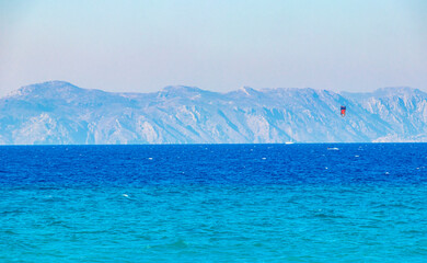 Fototapeta na wymiar Relax windsurfing vacation and turquoise waters Kremasti beach Rhodes Greece.