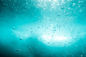 Underwater View of Bubbles In Deep Blue Ocean. Close Up Water. Background