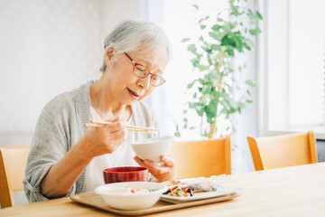 食事をする高齢者女性（食欲低下）
