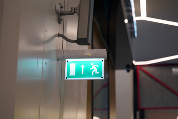 The emergency exit indicator is green with illumination from the inside.