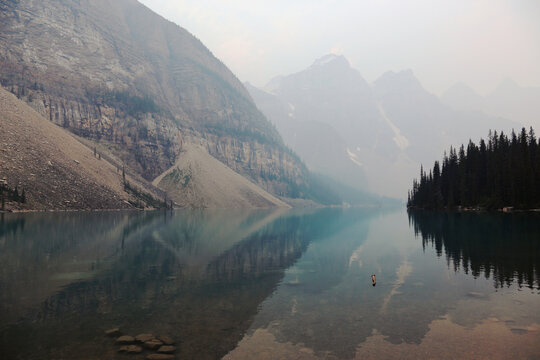 Iconic Moraine Lake In Banff National Park, Alberta, Canada.  Shot During The Summer Of 2021 It Was Hazy As A Result Of Smoke From Wildfires.