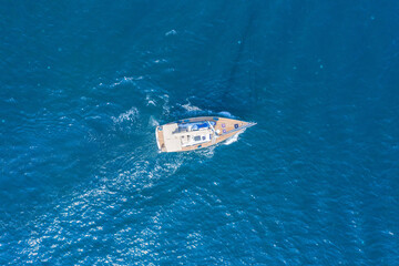 Fototapeta premium Boat on the water surface drone view.