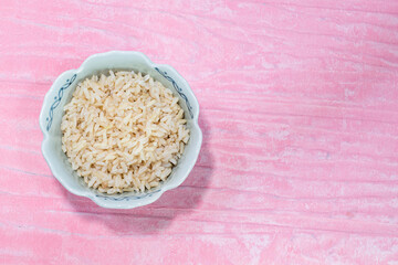 rice brown in bowl  isolated on pink background