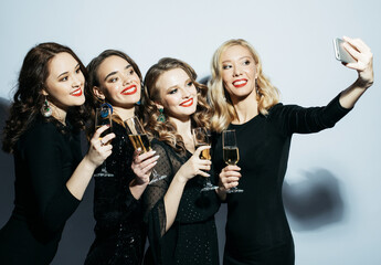 Close-up shot of group of laughing girls having party, take selfie with smartphone