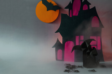 Two dark ghosts with black spiders in the fog against the background of a dark house with red...