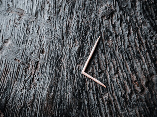 a broken toothpick fell on the black cement floor
