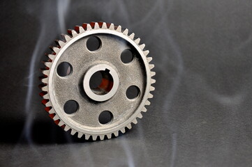 Engine parts. Pinion on a dark background. Spare parts.
