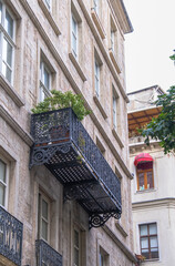 Fototapeta na wymiar Decorative balcony made of wrought iron in the historical apartment.