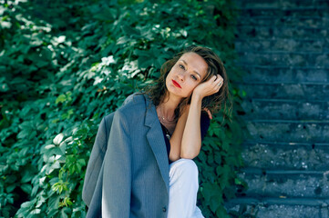 A young carefree woman is resting in a city park