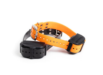 Dog shock or bark collar set. Large orange and black remote training collar for dogs. Device used for obedience training, recall or to reduce or stop barking. Selective focus. Isolated on white.