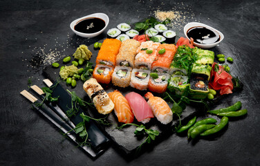 Sushi and roll set on dark background. Traditional food concept.