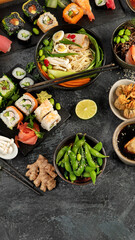 Japanese dishes and snacks on gray background.