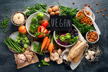 Vegan food assortment on dark background.