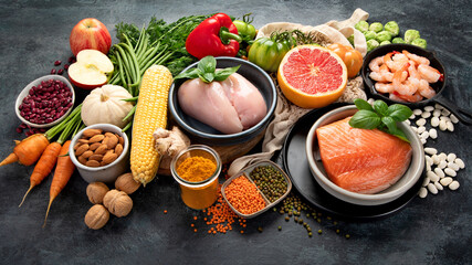 Healthy food assortment on dark background.