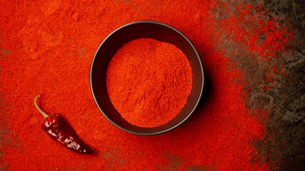 TOP VIEW: Dish with red pepper powder from a table - 457637881
