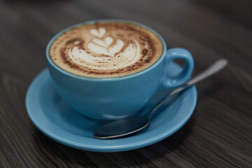 cup of cappuccino on blue cup