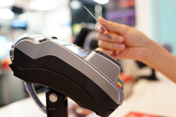 Customer paying with NFC technology on credit card