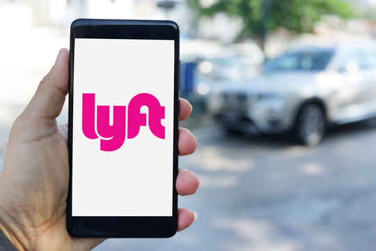 A man is using Lyft mobile app on smartphone. Lyft is a transportation network company based in San Francisco, California. PENANG, MALAYSIA - NOVEMBER 23, 2017.